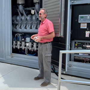 Dr. Steurer standing in front of a machine